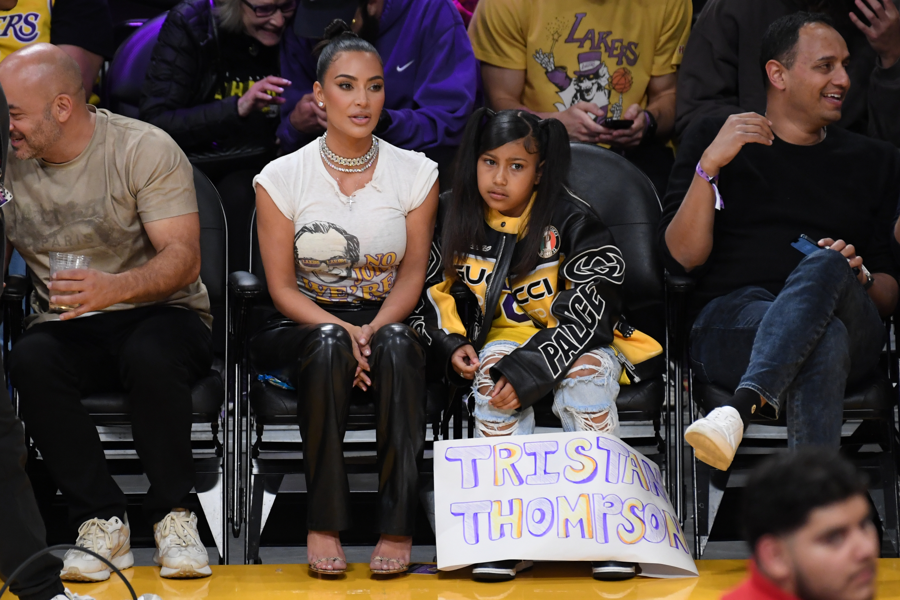 Kim and North at a basketball game. North has a sign that says, &quot;Tristan Thompson&quot; at her feet