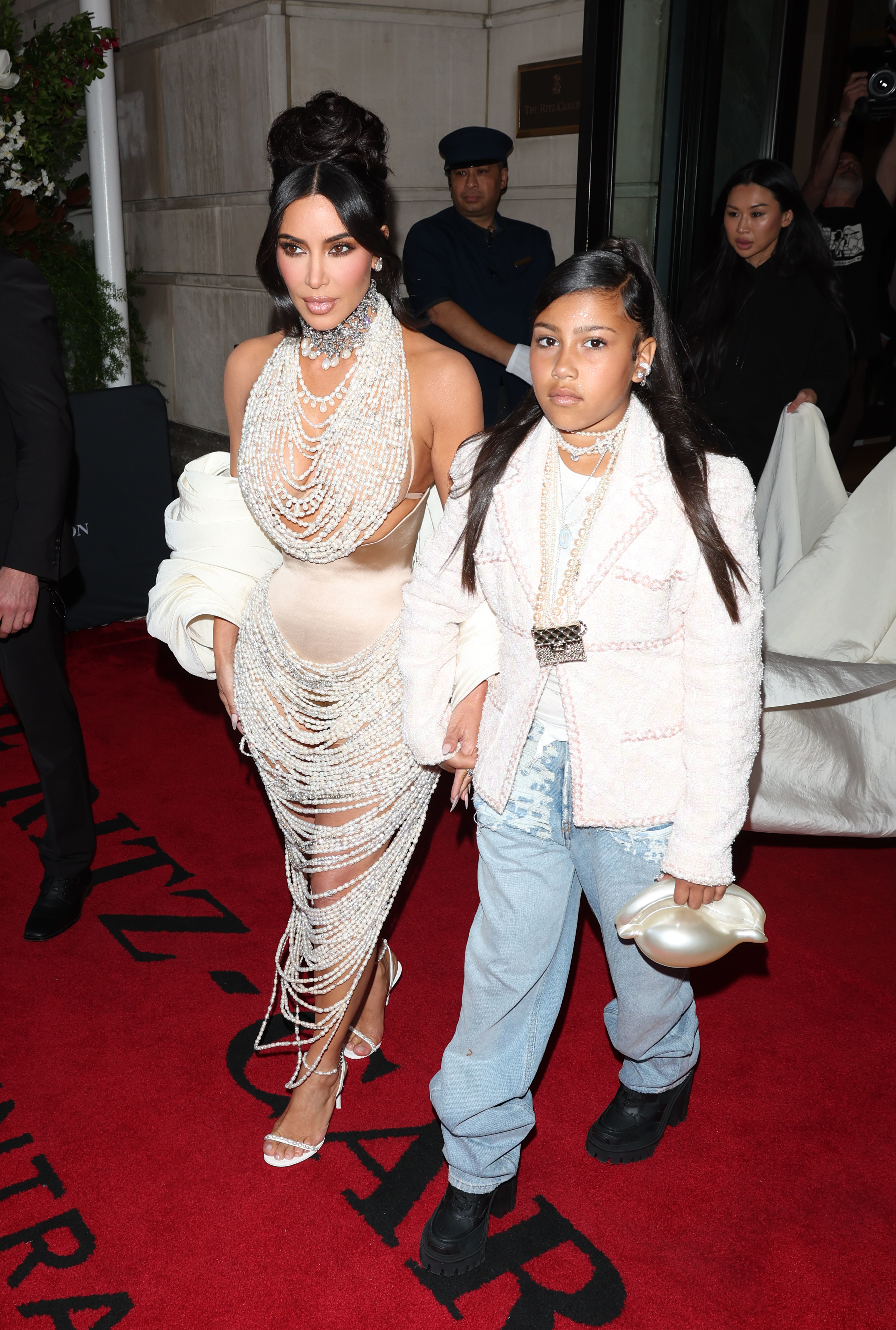 Kim Kardashian and North West walking out of a hotel on the way to an event