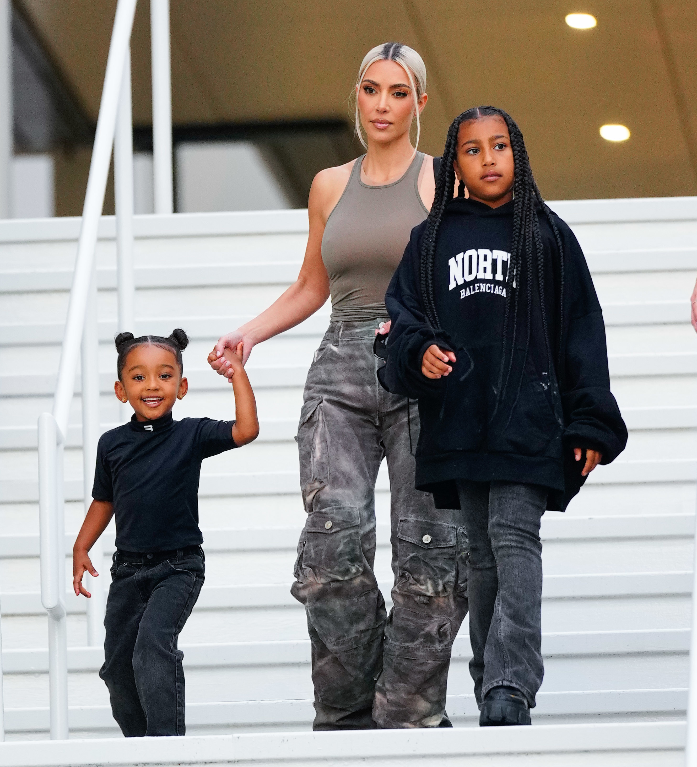 Kim with two of her children, including North, walking down steps