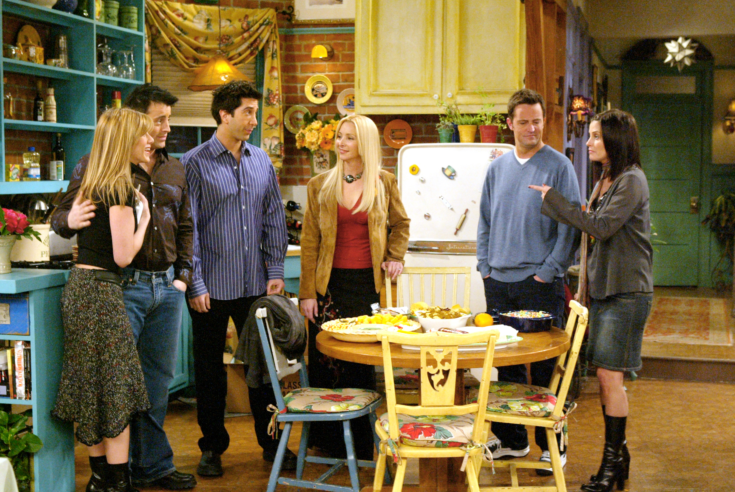 Screenshot from &quot;Friends&quot; of the cast standing in the kitchen