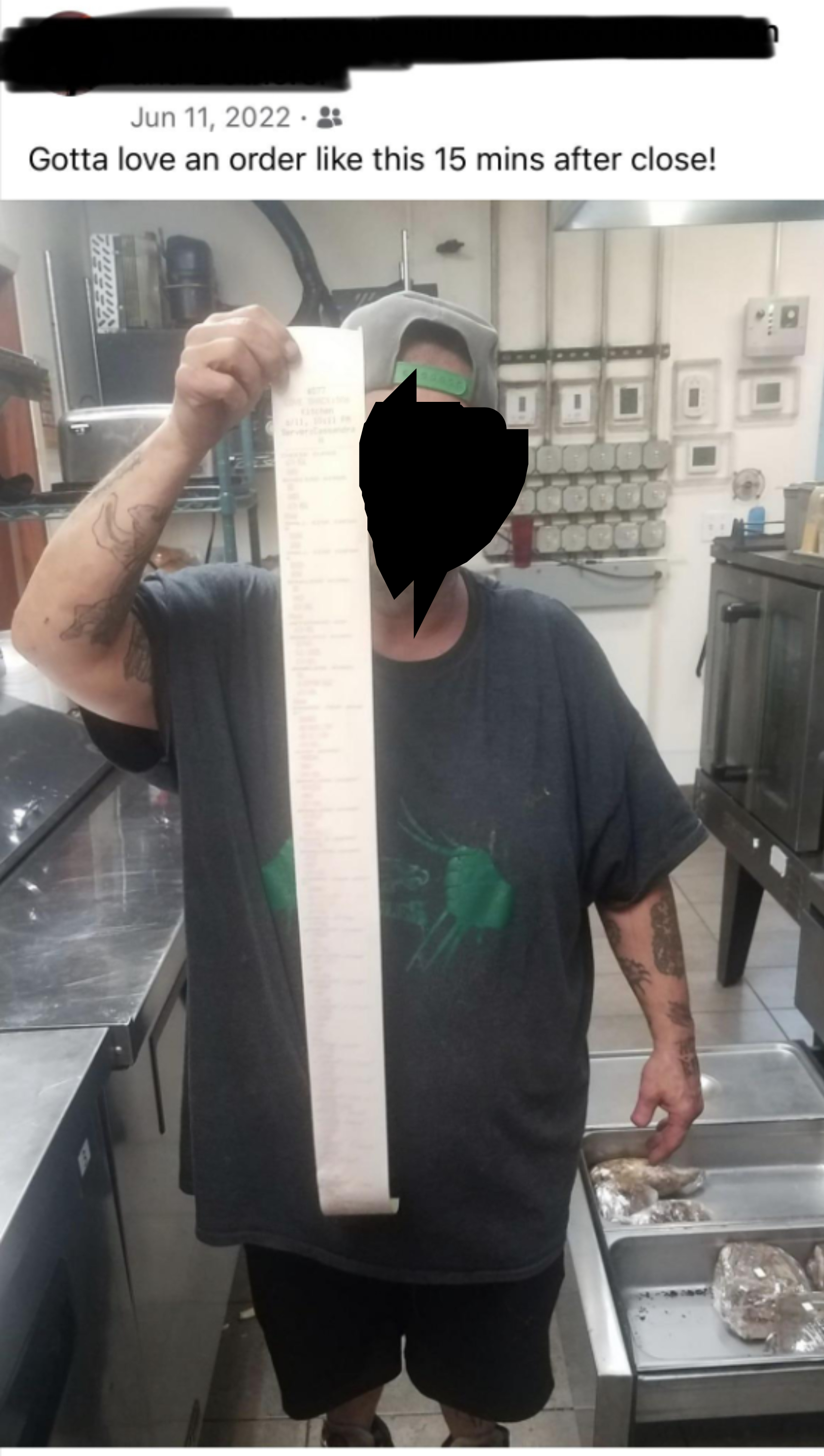a cook holding a very long receipt