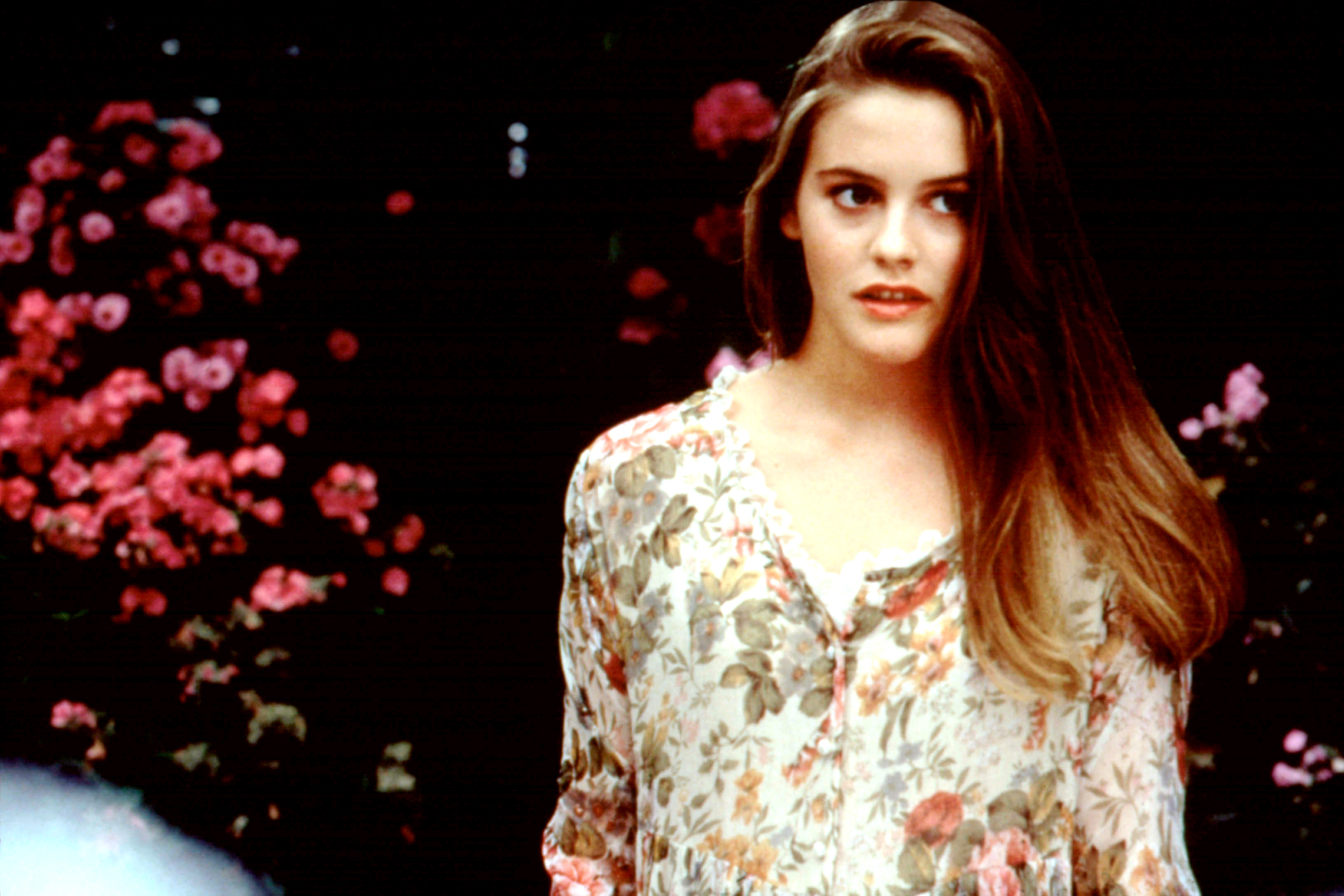 closeup of her in a floral shirt in the film
