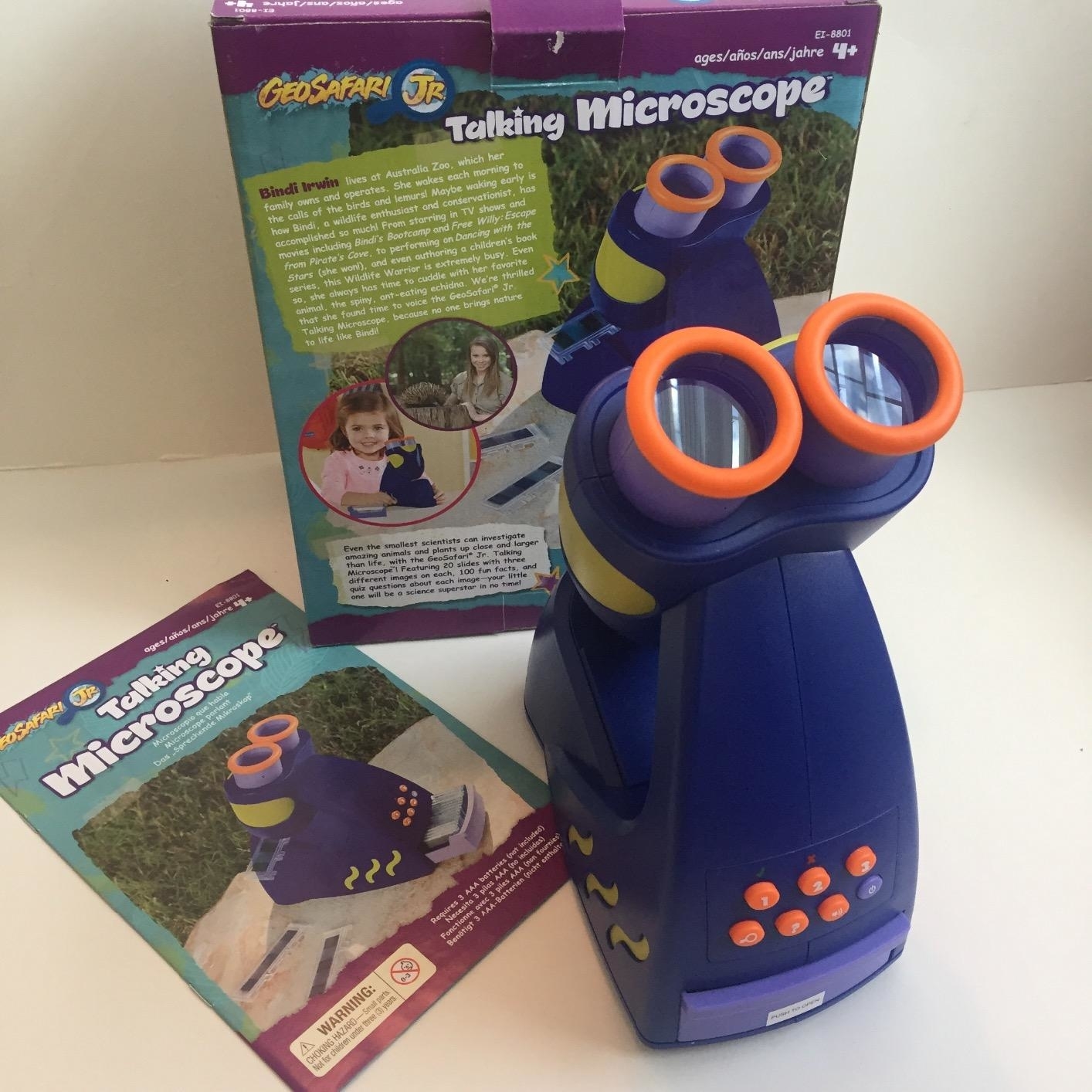 The microscope next to the box and instructions