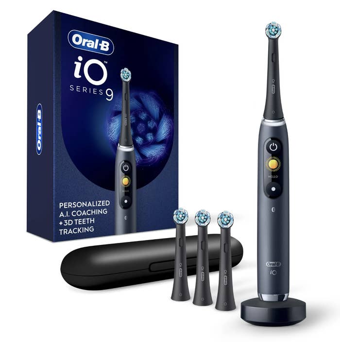 Oral B electric toothbrush with four heads, case, and charging base