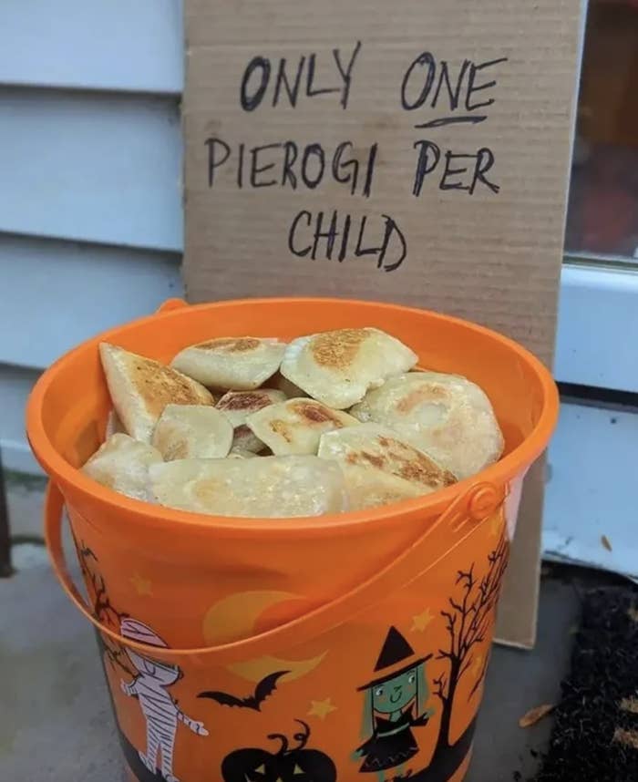 A bucket of pierogis with a sign that says, "only one pierogi per child"