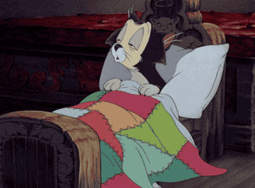 gif of a cartoon cat waking up in bed