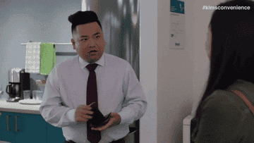gif of a man putting away his wallet