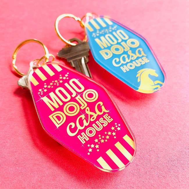 blue and pink keychains that read 