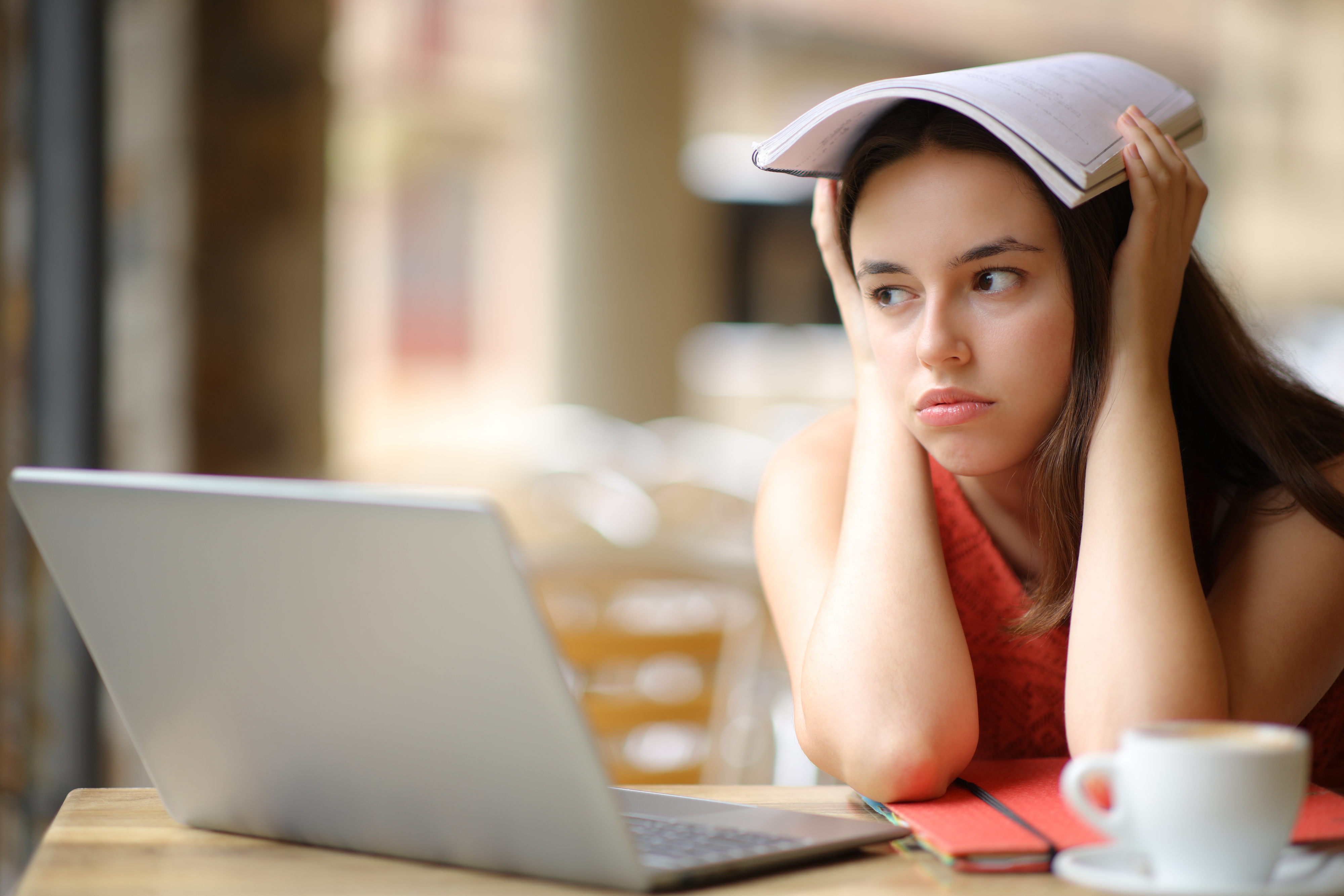 Frustrated student distracted in a cafe