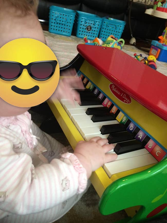 image of reviewer's toddler playing the little piano