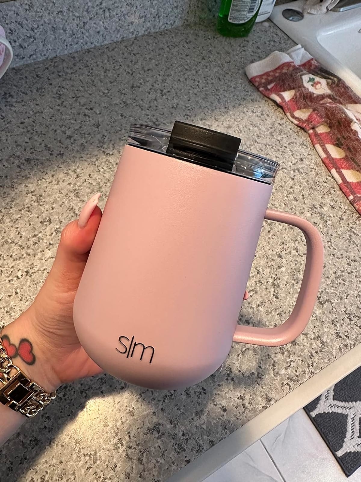 reviewer holding the pink mug