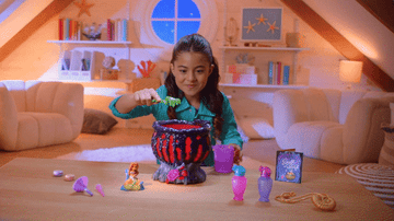 gif of a child playing with Ursula&#x27;s cauldron