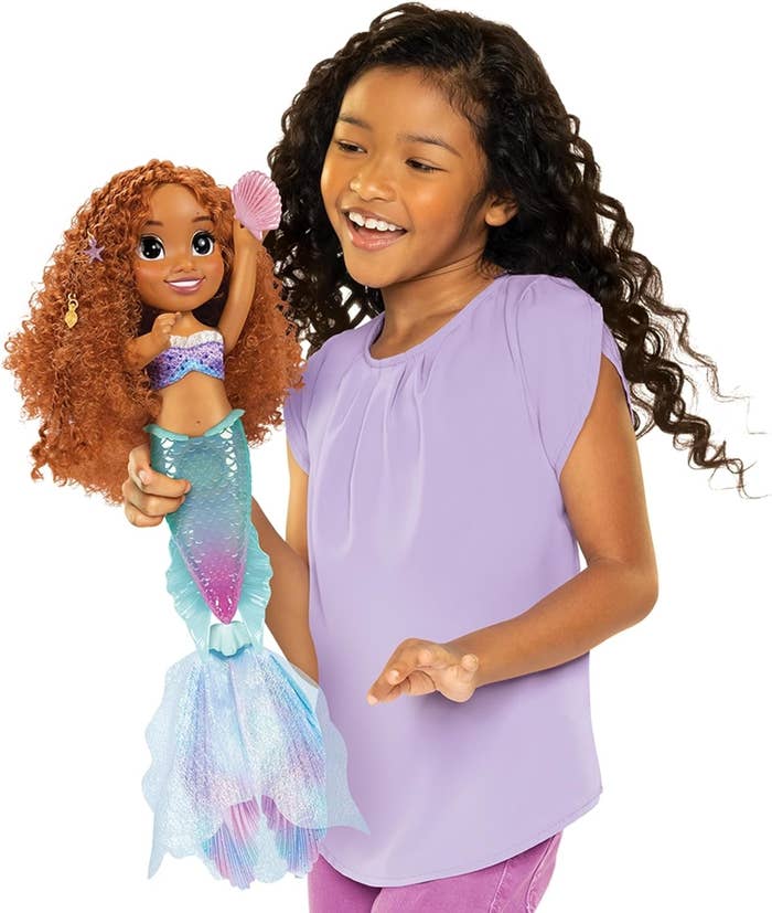 a child playing with the Ariel doll