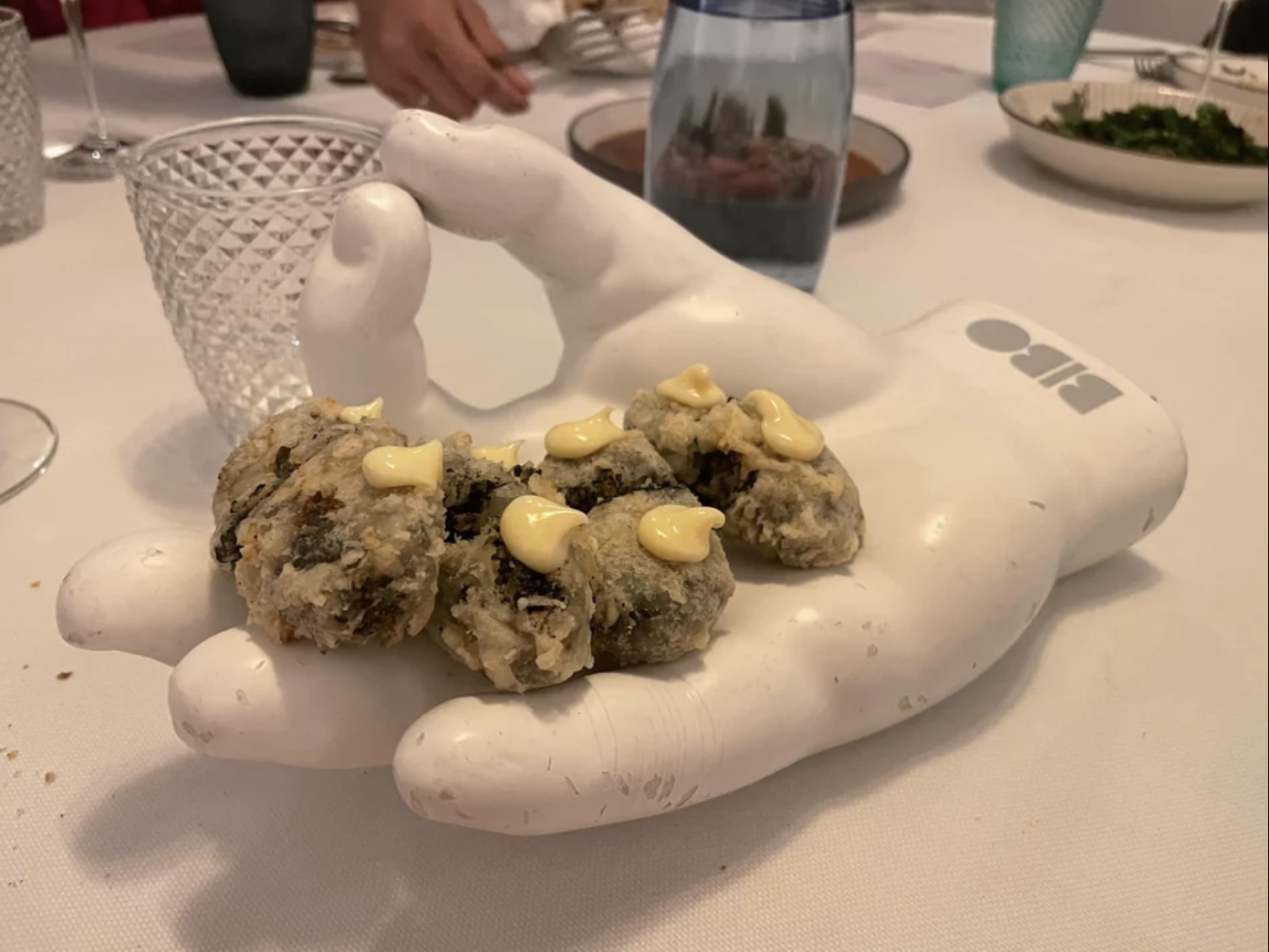 Croquettes are served on a fake hand