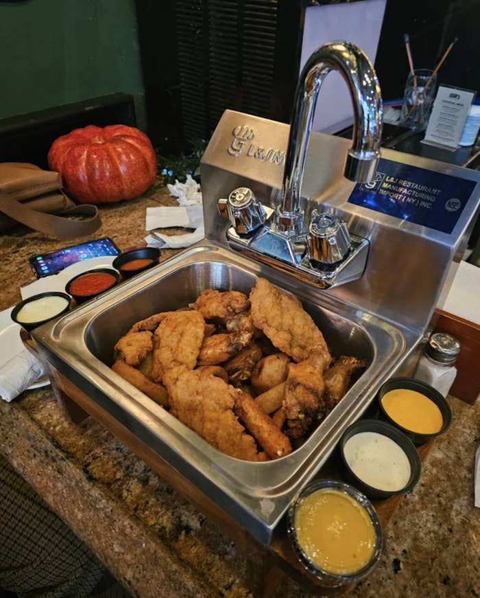 A pile of fried chicken is served inside a sink