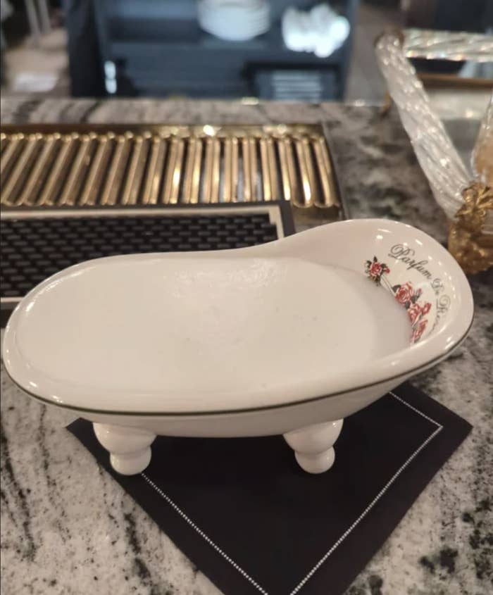 A gin cocktail is served in a tiny bathtub