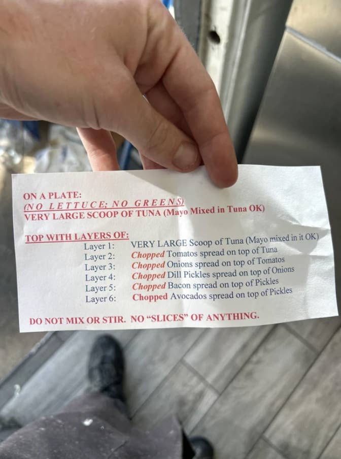 Typed instructions: "No lettuce, no greens; very large scoop of tuna, topped with five layers: chopped tomatoes on tuna, chopped onions on tomatoes, chopped dill pickles on onions, and bacon and avocado on pickles; do not mix or stir, no 'slices'"