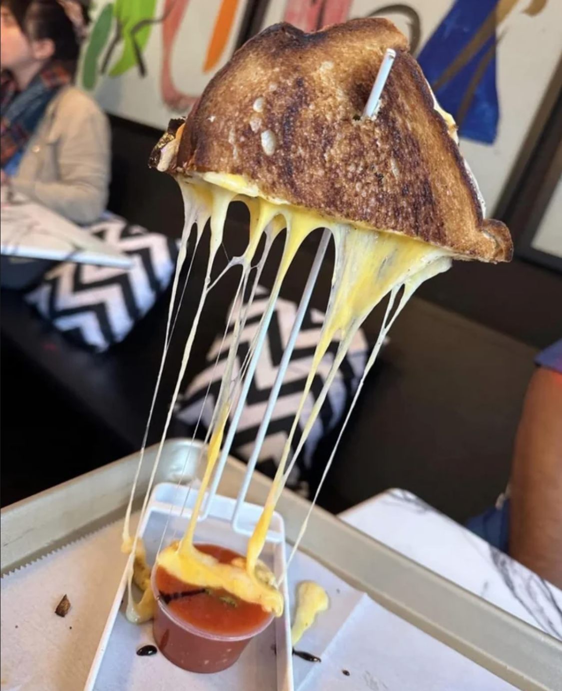 A grilled cheese is impaled