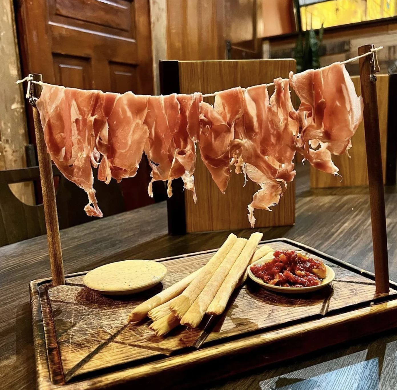 Prosciutto is hung up on a clothesline
