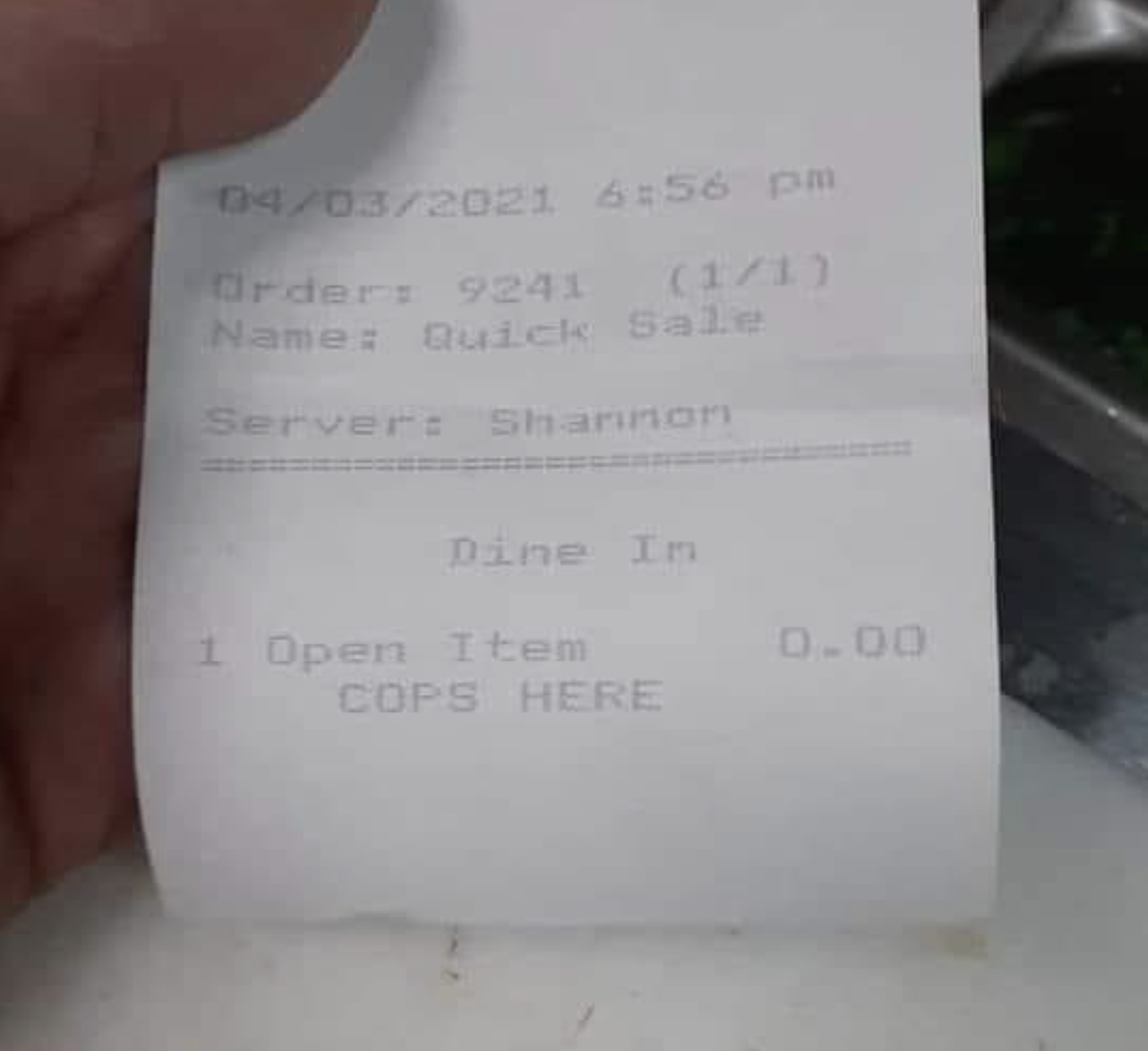 A receipt with. message at bottom: &quot;COPS HERE&quot;