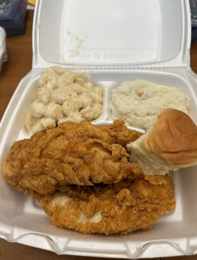 Takeout plate of fried chicken and roll, mac &#x27;n&#x27; cheese, and what looks like potato salad