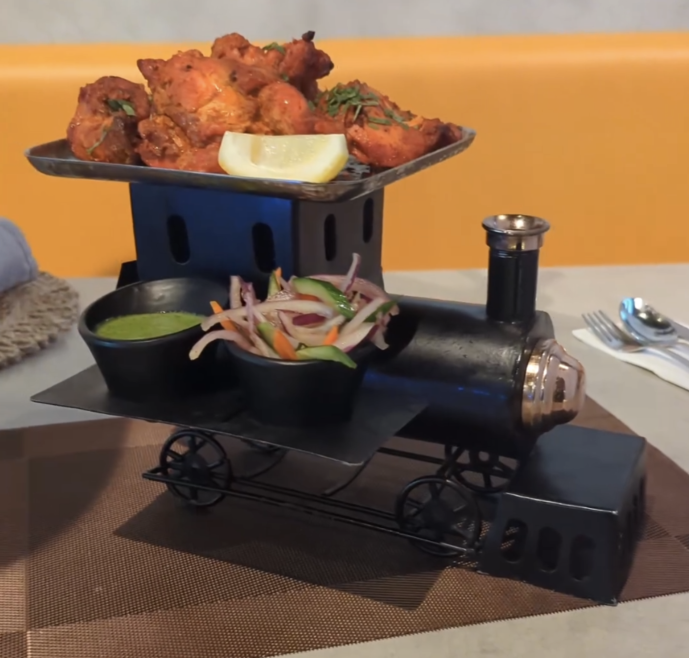Salsa and veggies are served on a little train