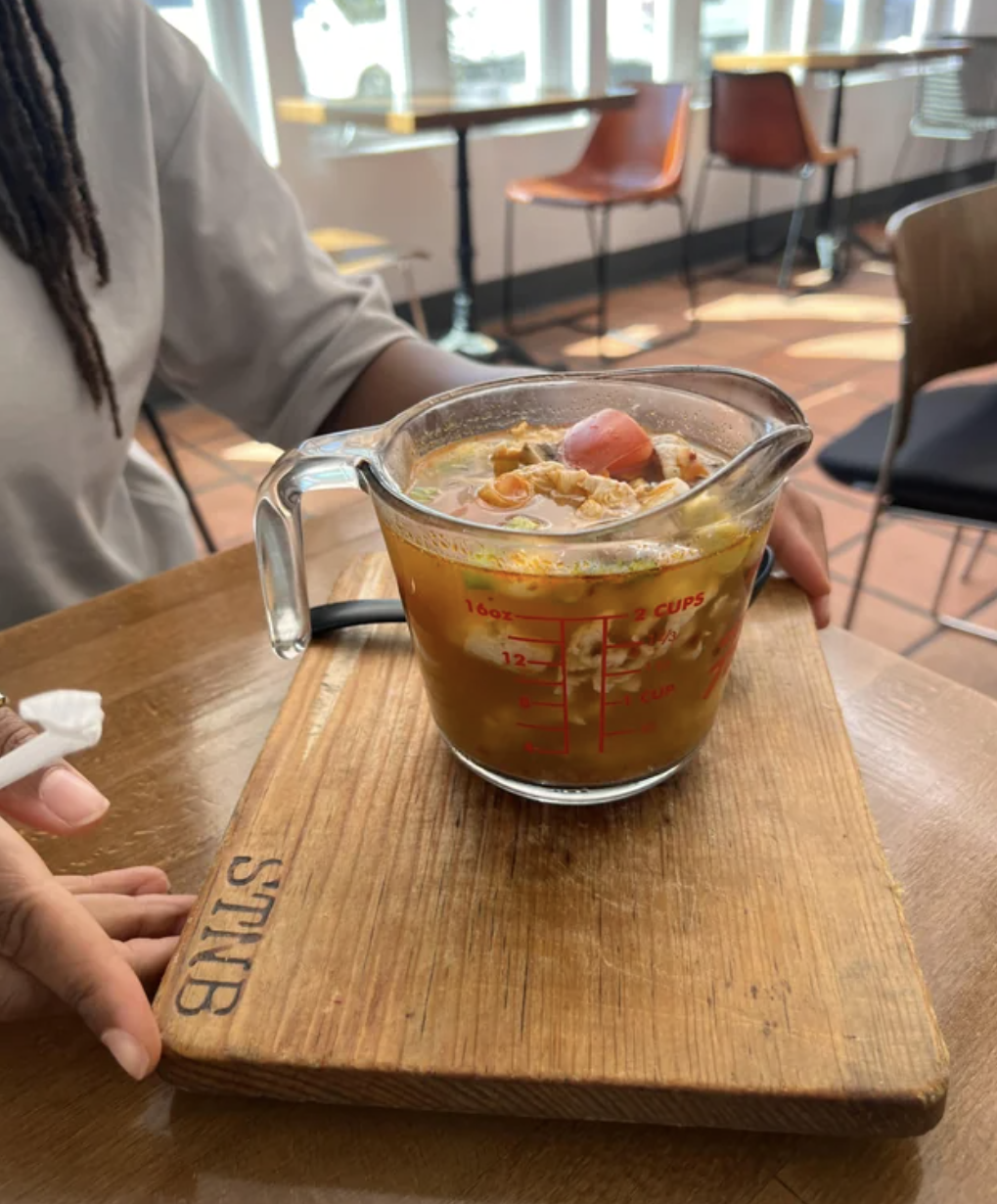 Soup is served in a measuring cup
