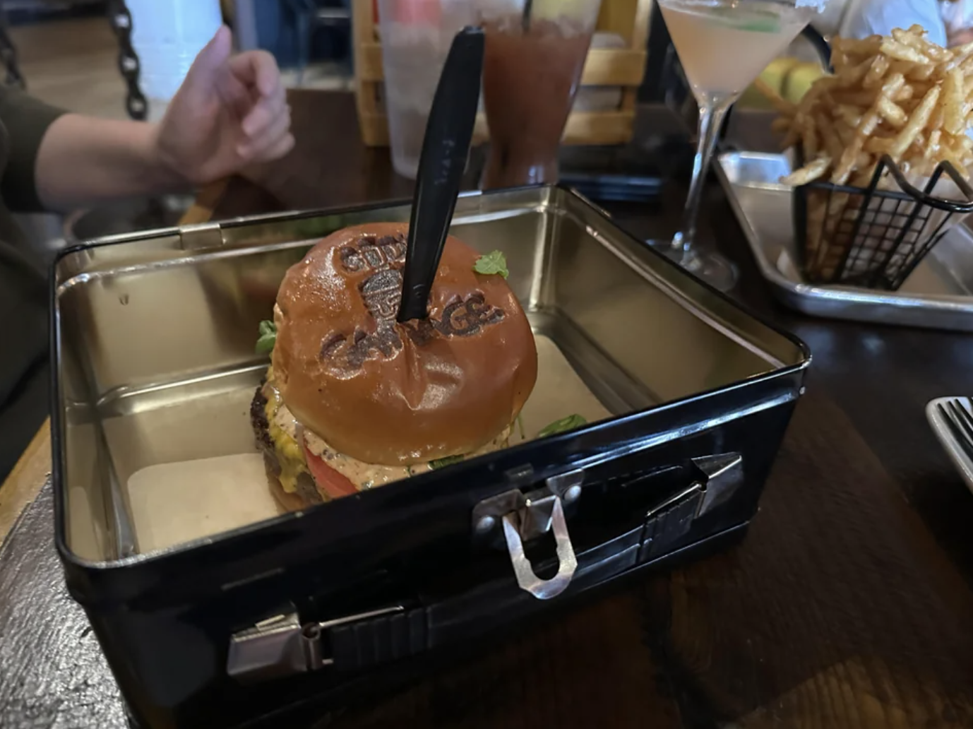 A burger is served in a lunch box