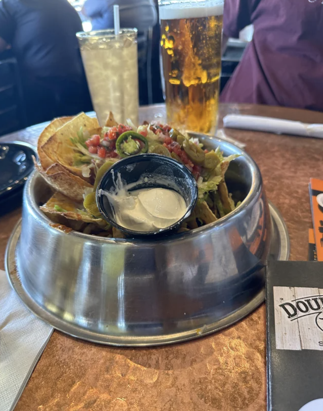 There are nachos in a dog bowl