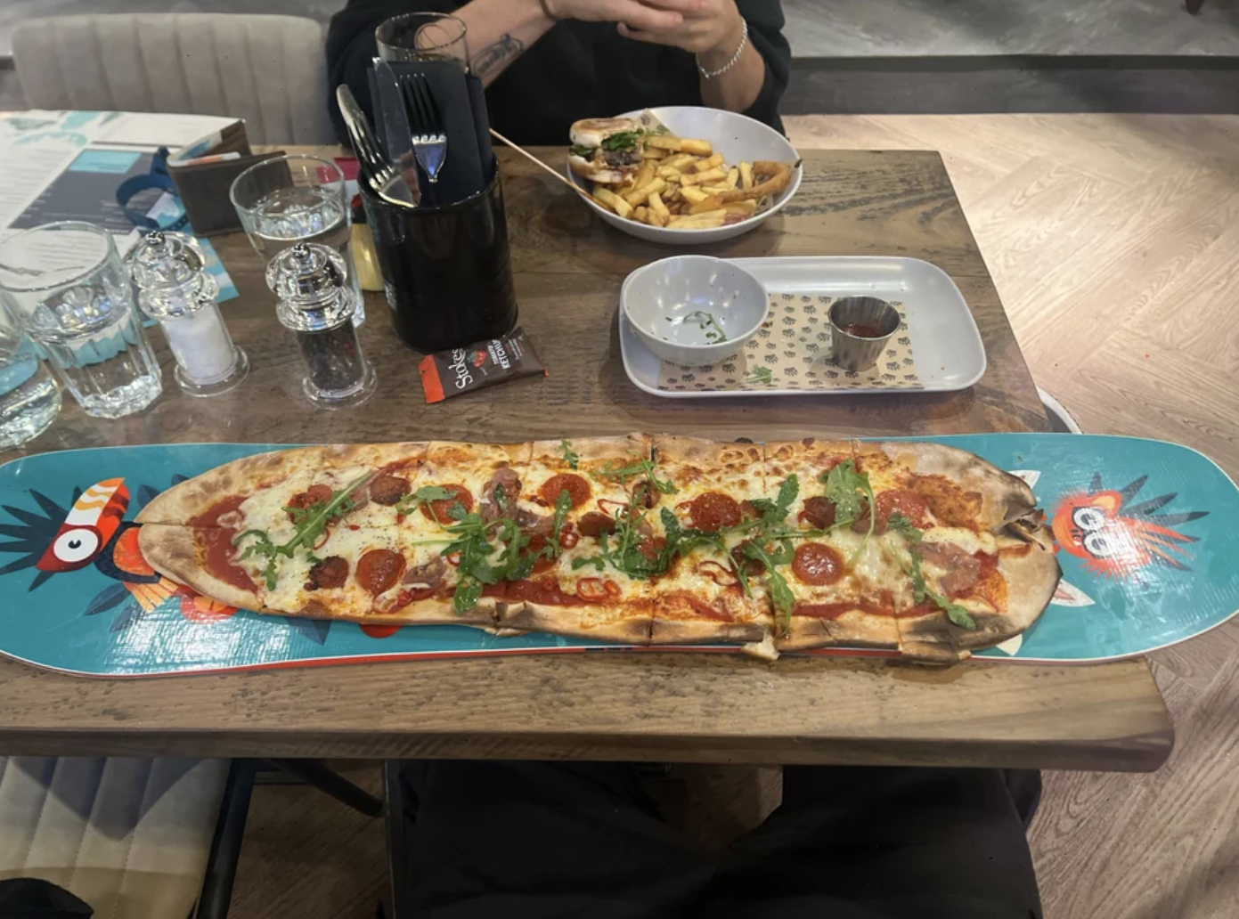 There's a flatbread pizza on a skateboard