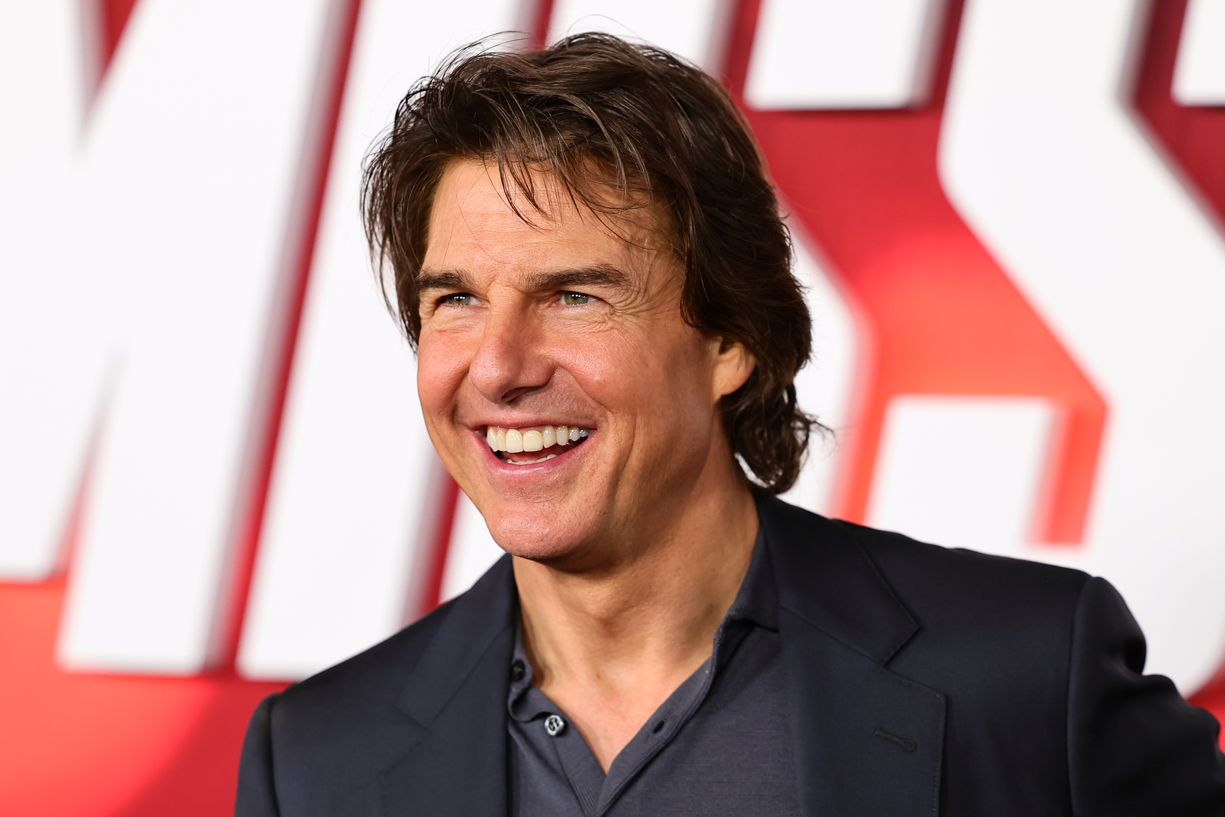 Close-up of Tom Cruise smiling at a media event