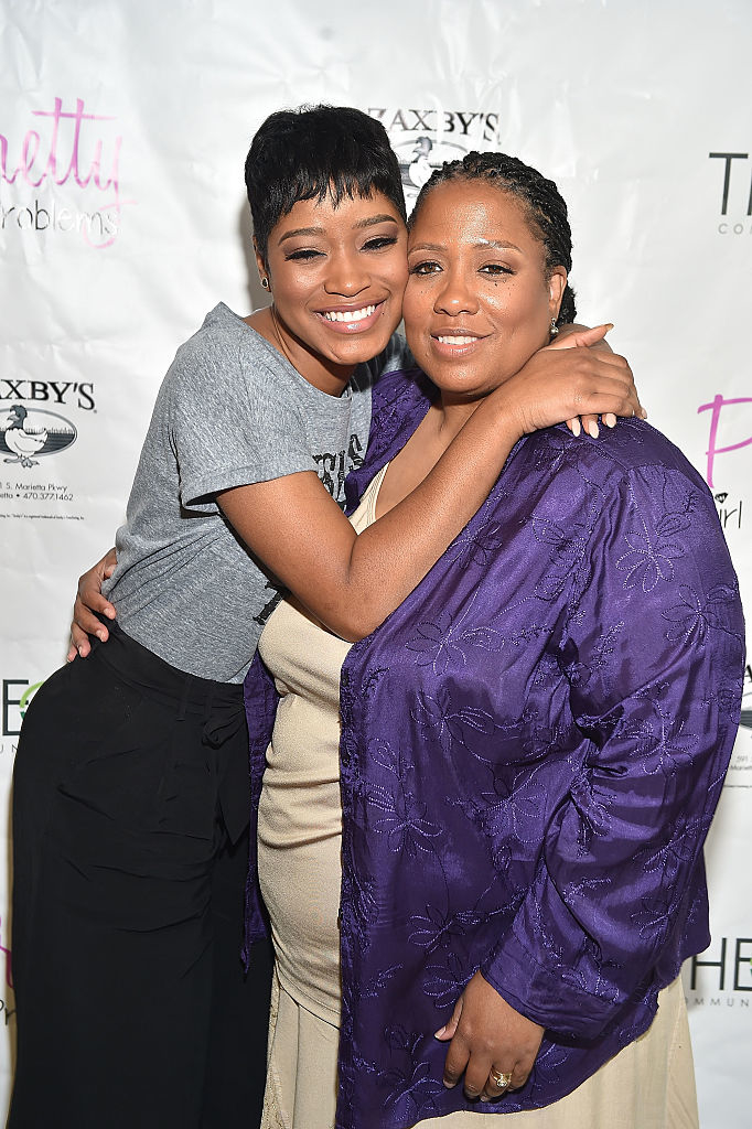Close-up of Keke and Sharon hugging and smiling at a media event