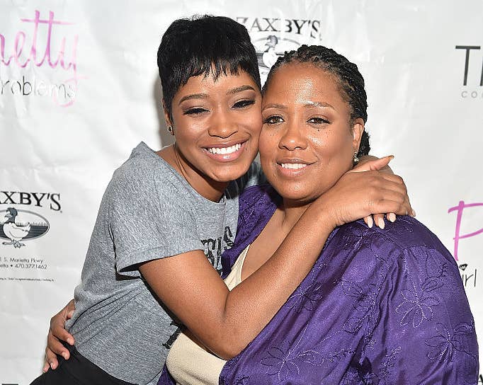 Close-up of Keke and Sharon hugging and smiling at a media event
