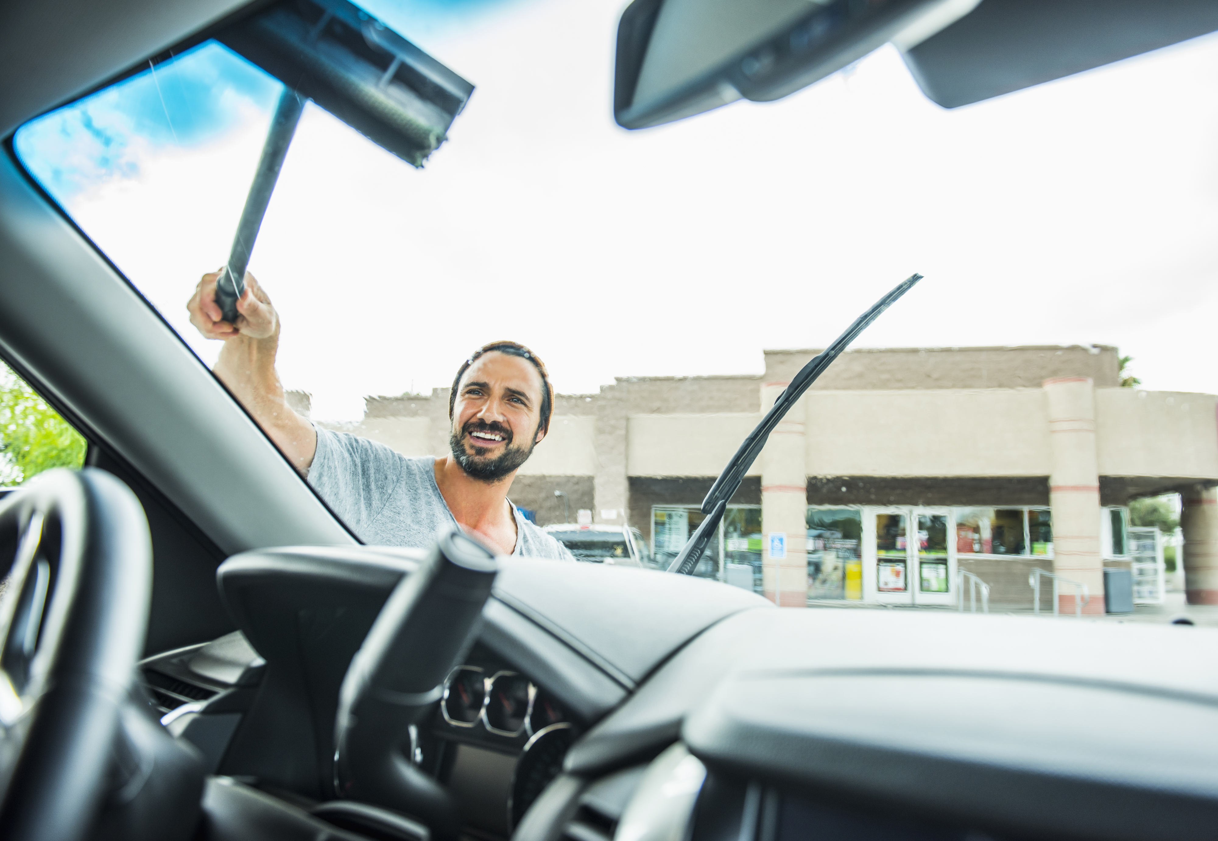 a man washing windshield