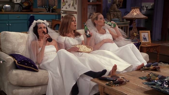 Monica, Rachel, and Phoebe from &quot;Friends&quot; are in wedding dresses and drinking wine