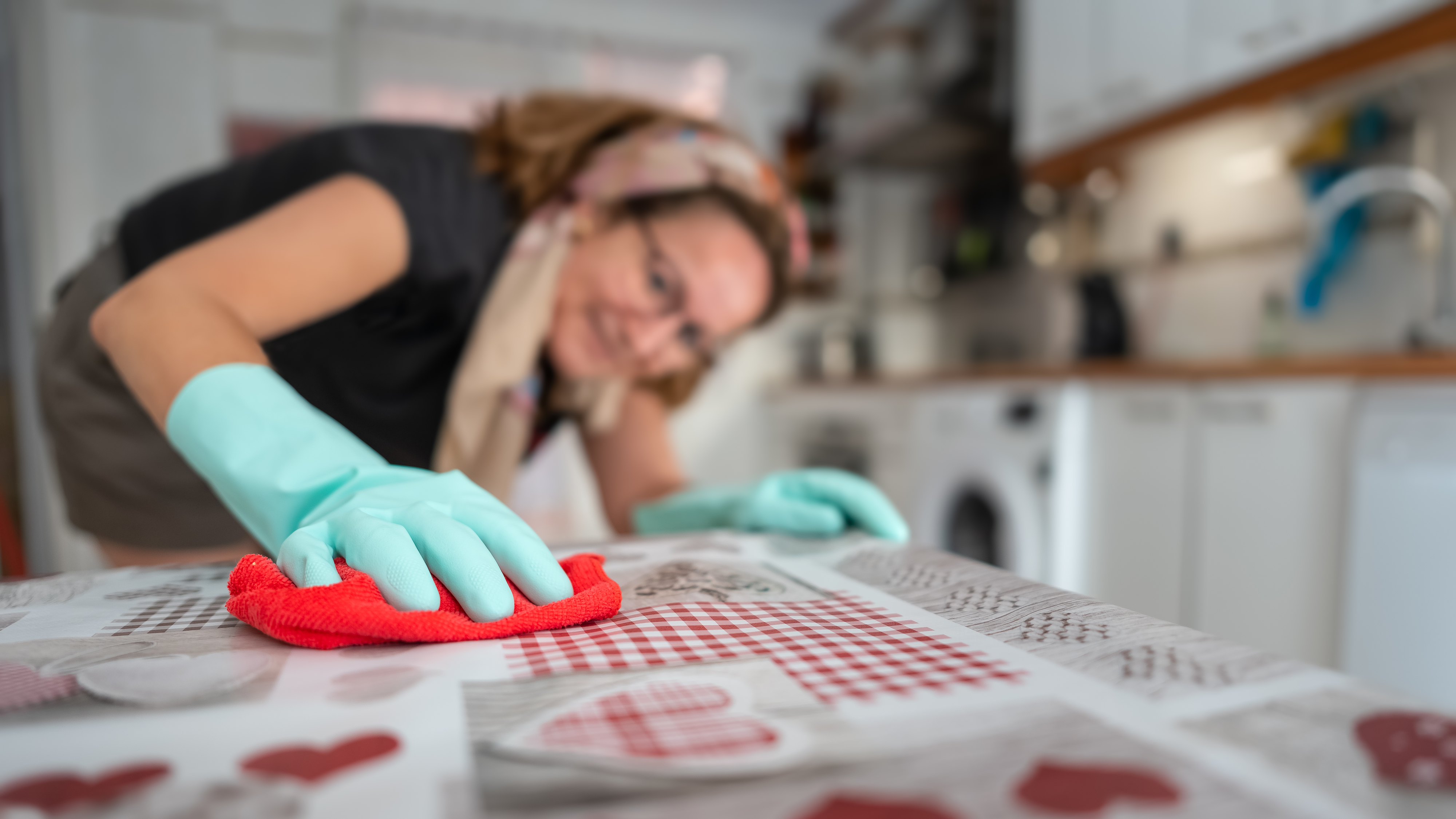 Woman wiping down kitchen table