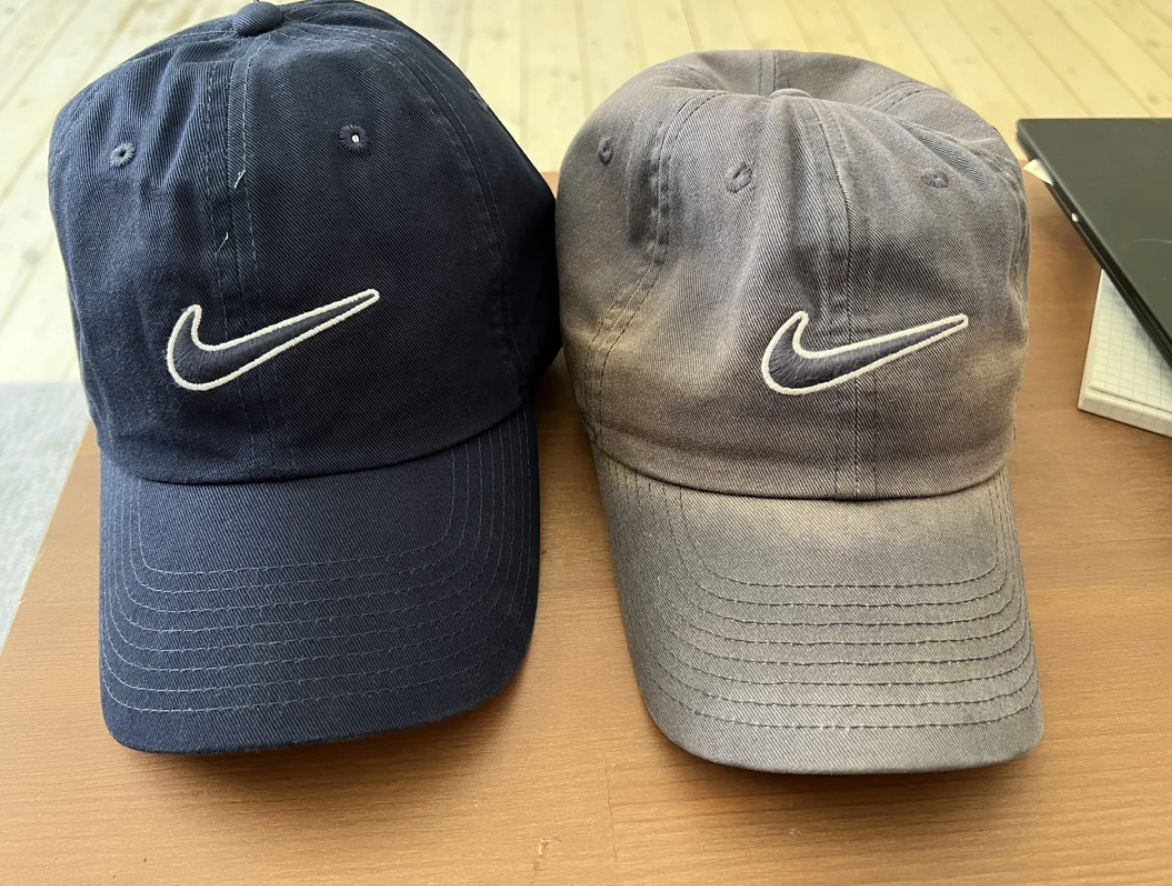 The old one is a dusty gray, next to the dark blue new cap