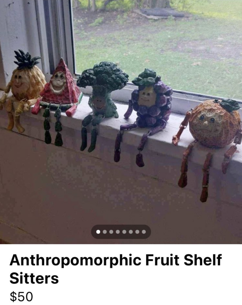fruit figures sitting on a window sill that are for sale