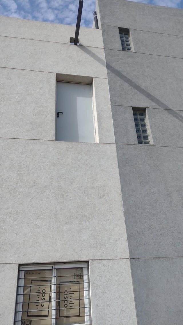 door at the top of the building with no way to get to it from the outside