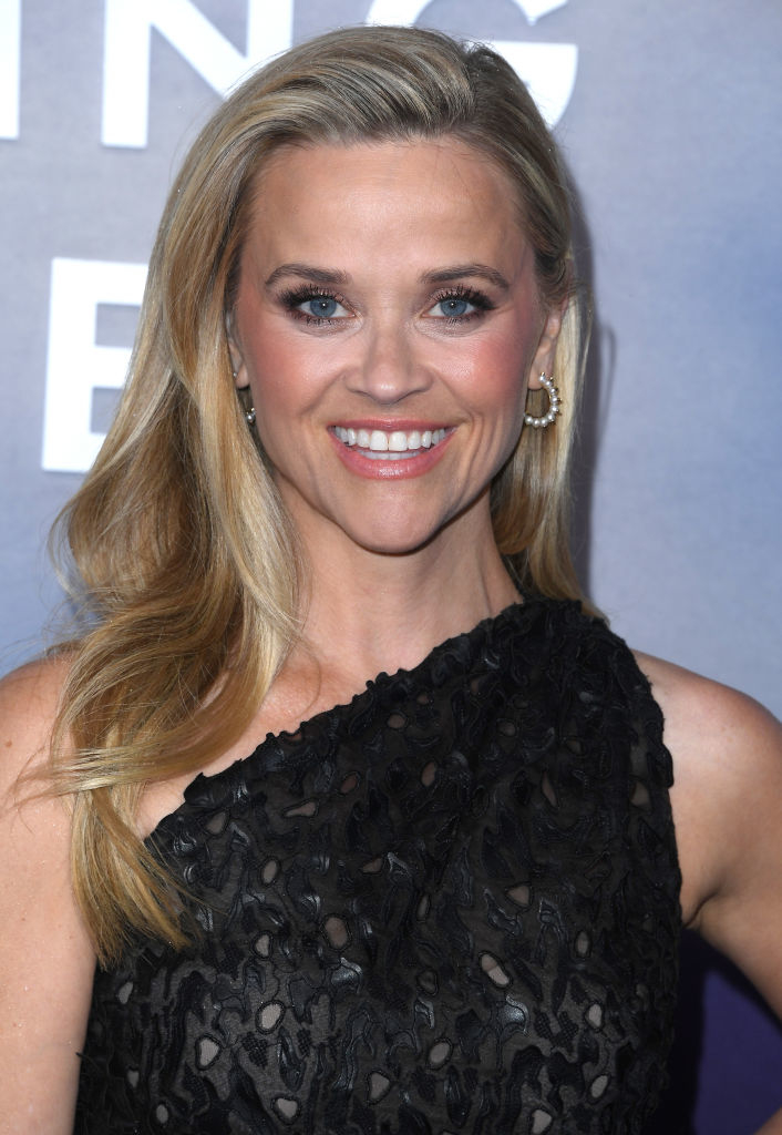 Close-up of Reese smiling at a media event