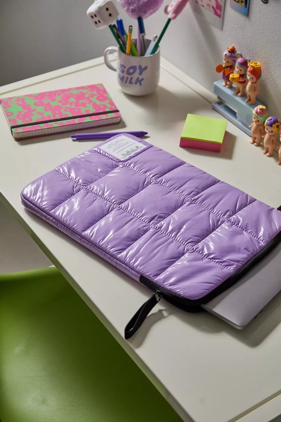 purple puffy laptop sleeve on desk