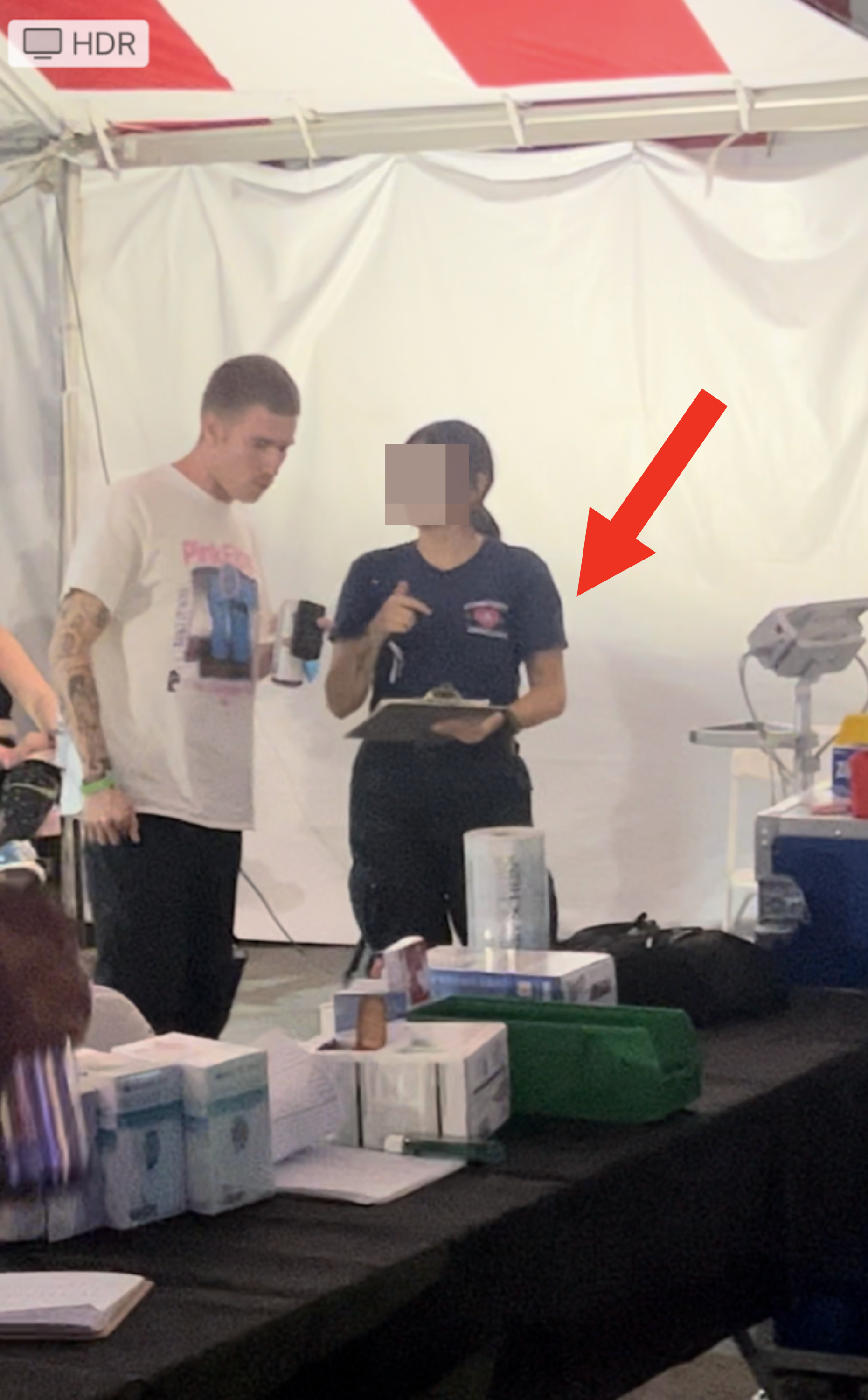 Cami's friend speaking with a doctor in the medical tent