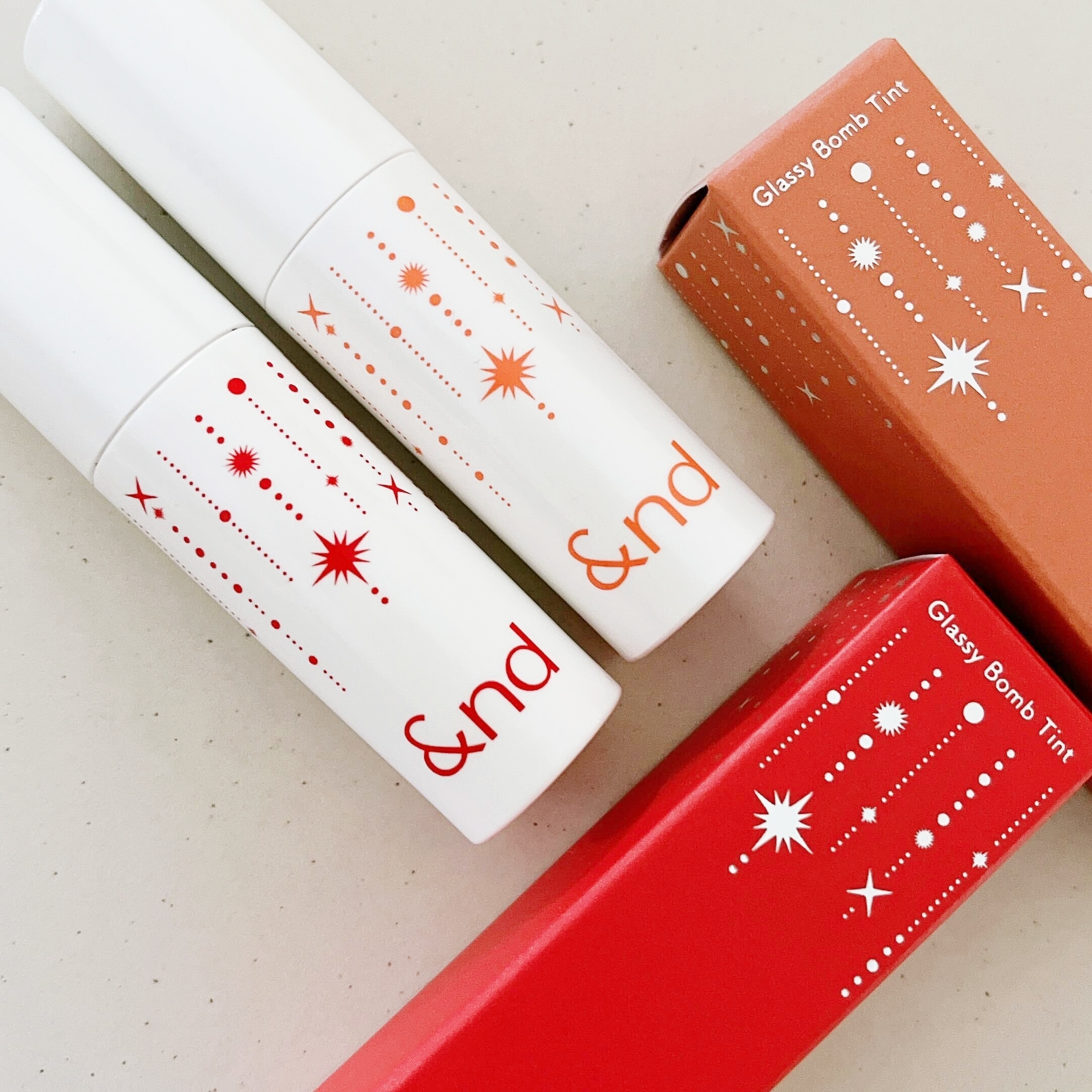 LAWSON(ローソン)のオススメのコスメ「&nd by rom&nd グラッシーボムティントレッドフレーク」「&nd by rom&nd グラッシーボムティントコーラルスノー」