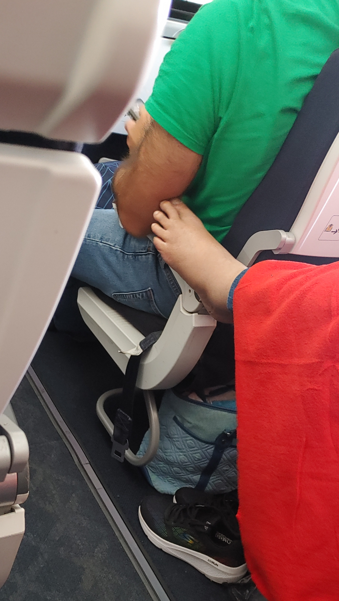 Someone&#x27;s foot touching a man&#x27;s arm