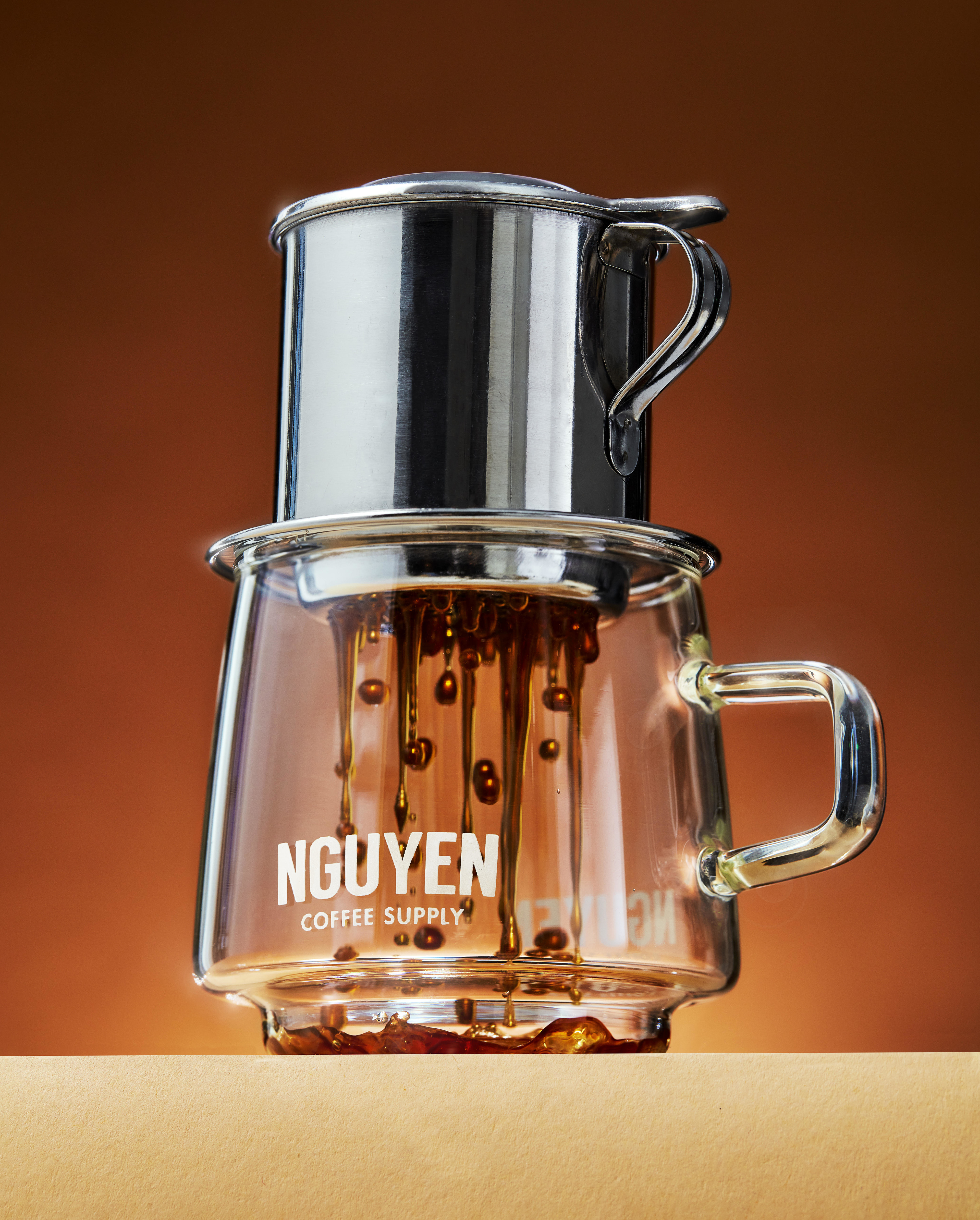 vietnamese phin filter over nguyen coffee supply branded glass mug