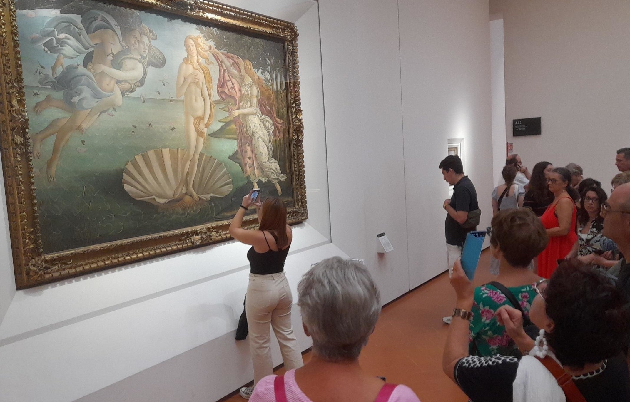 A woman in everyone&#x27;s way while looking at a painting