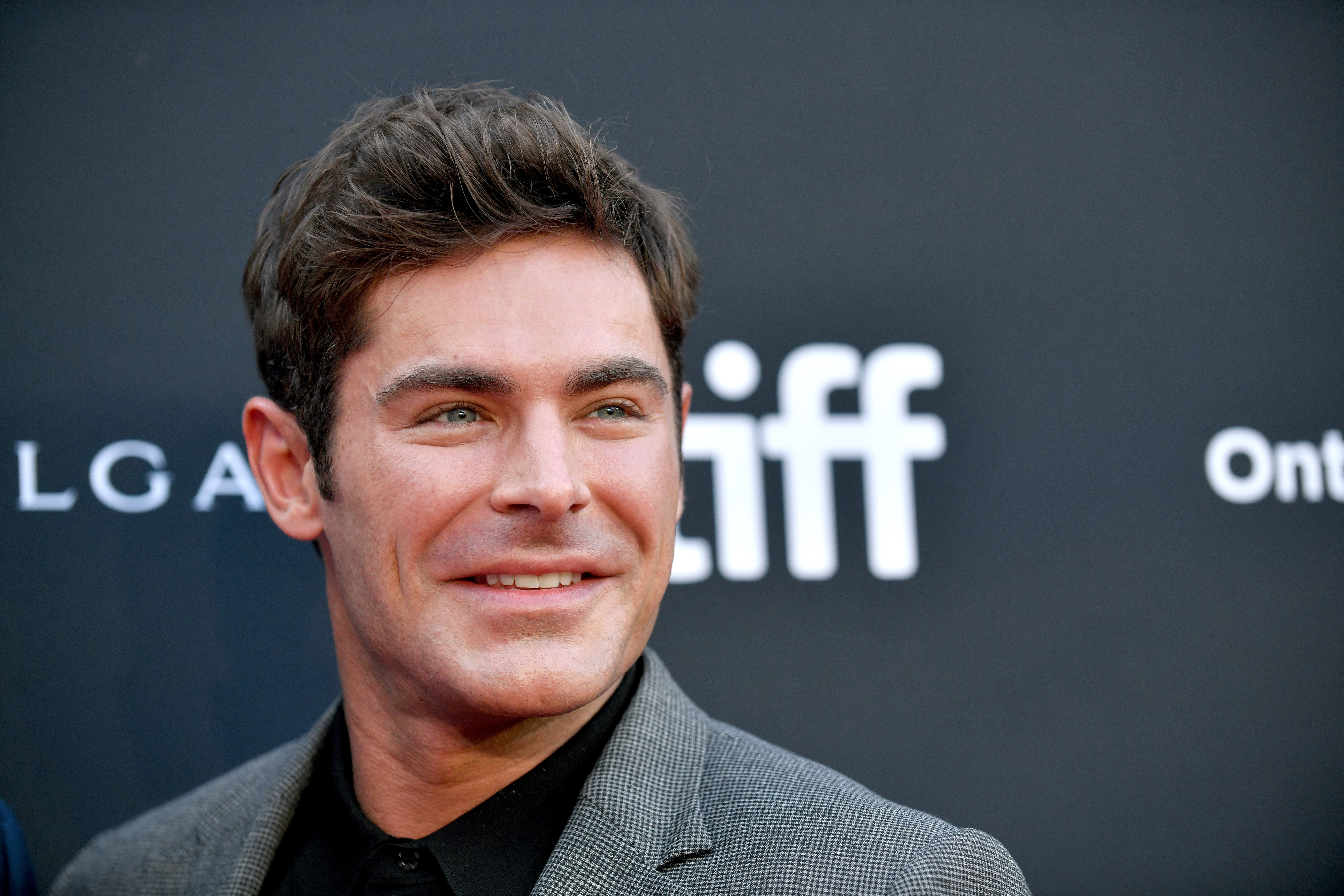Close-up of Zac smiling at a media event