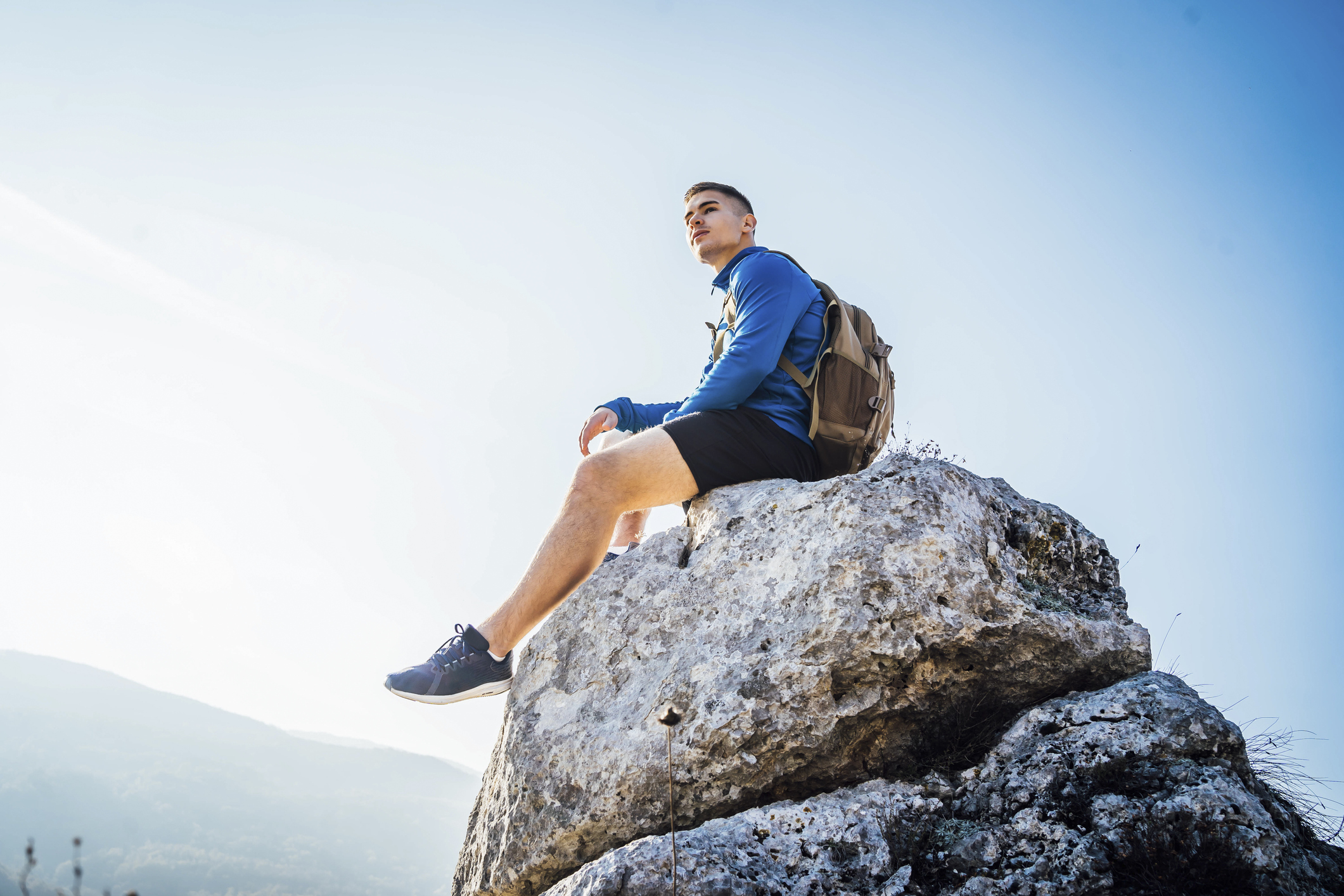 A backpacker sitting on a rock