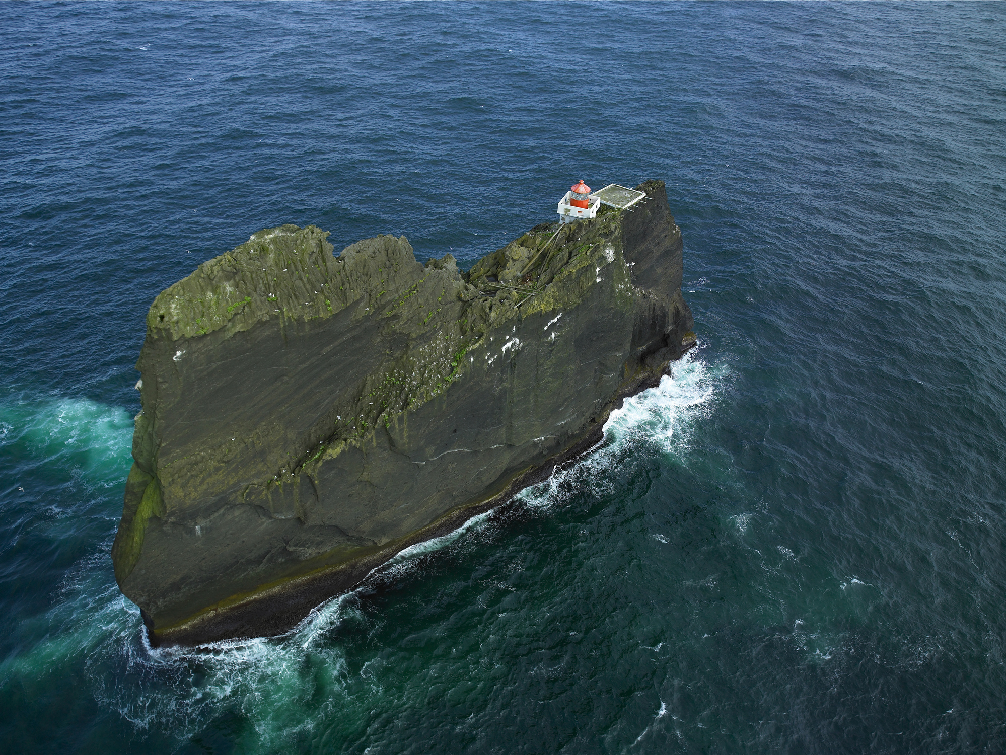 Overhead shot of a lighthouse on a small island
