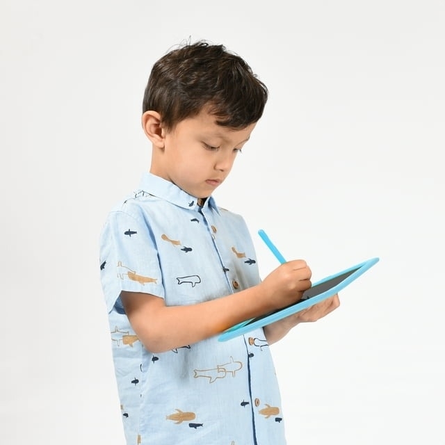 kid using blue LCD writing tablet and doodle pad